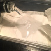 Vodka being poured onto a soft cloth to be used in an ice pack.