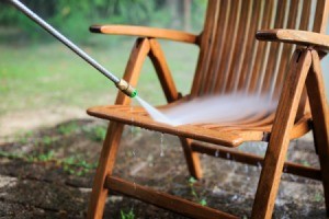 Pressure washing outdoor wooden chair.