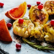 Chicken legs with cranberries and oranges.