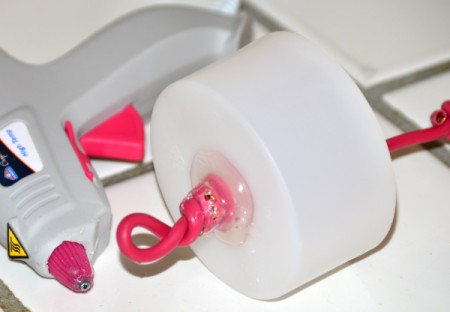 DIY Moat to Keep Ants Out of Hummingbird Feeder - apply hot glue on the outside around the bottom opening for the wire