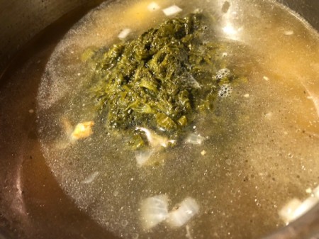 spinach and broth added to pot