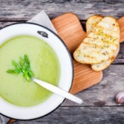 Asparagus Soup  in a bowl with piece of bread.