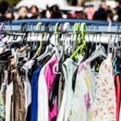 Dresses on a clothing rack at a thrift store.