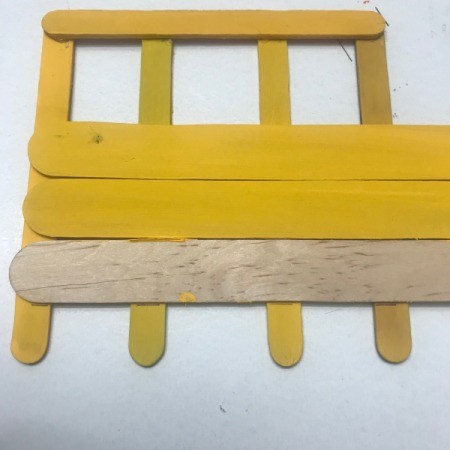 Hanging School Bus Picture Frame - using an unpainted craft stick to draw the cut line