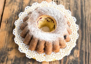 Round pound cake topped with powdered sugar.