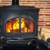 Wood stove with fire roaring inside.