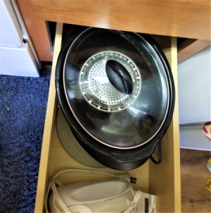 Small kitchen items stored inside a crockpot.