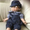 Identifying a Porcelain Doll - boy doll wearing a cap, plaid shirt and overalls