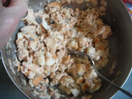 mixing bagel pieces, salmon and egg