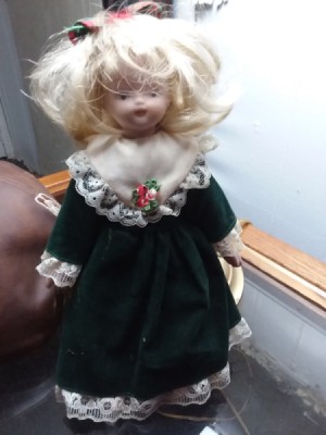 Identifying a Porcelain Doll - doll wearing a dark blue dress with lace at bottom and sleeves