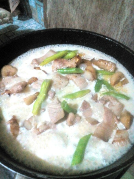 adding coconut milk to skillet