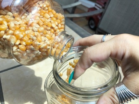 Popcorn Kernel Jar Secret Safe - put the bottle into the jar and pour popcorn kernels around it against the side of the outer jar