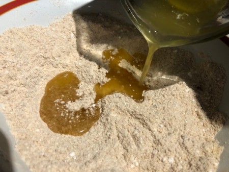 adding melted butter to dry ingredients
