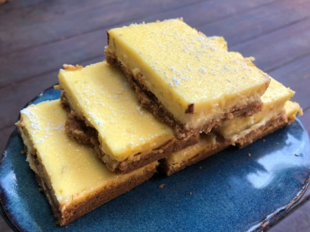 Zesty Lime Cheesecake Bars stacked on plate
