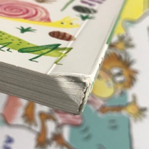 A board book with a damaged and bent spine, due to poor packaging during shipping.