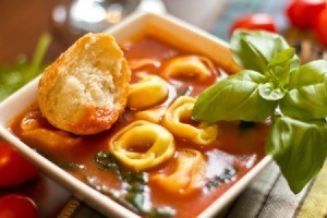 Italian Tortellini Soup with a piece of bread.