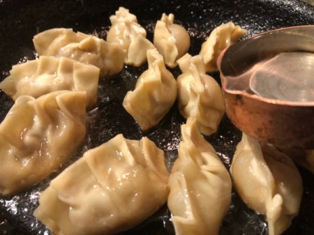 adding water to Potstickers