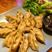 Potstickers on plate with dipping sauce