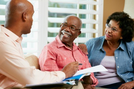 Financial advisor going over some notes with senior couple