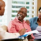 Financial advisor going over some notes with senior couple