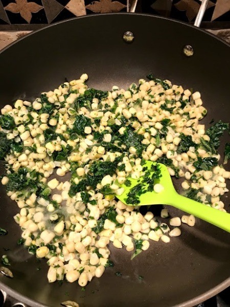 spinach and corn in skillet