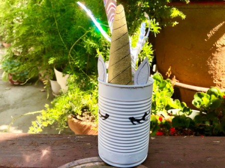 Tin Can Unicorn Planter - unicorn outside with the tail blowing in the wind