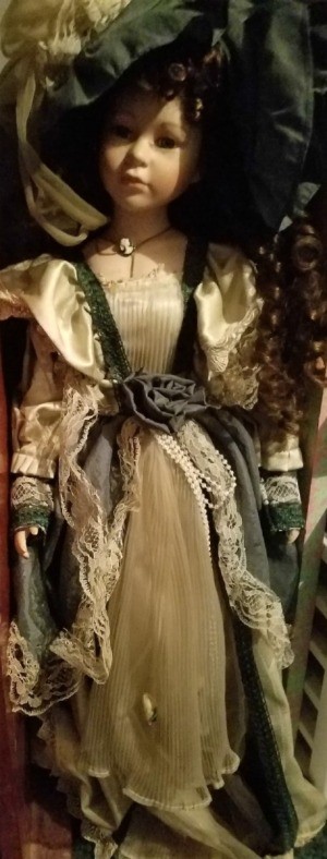 Identifying a Porcelain Doll - doll dressed in period attire of green and tan