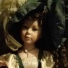 Identifying a Porcelain Doll - doll dressed in period attire of green and tan