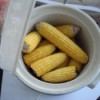 6 ears of cooked corn in a crockpot.