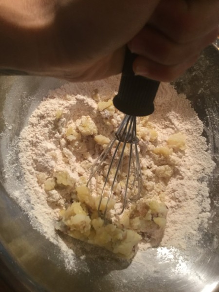 adding potato to flour