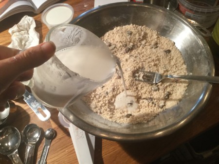 adding coconut milk to dough