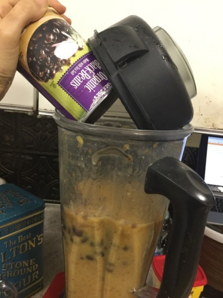 adding canned beans to blender