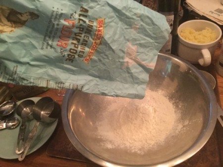 putting flour in bowl