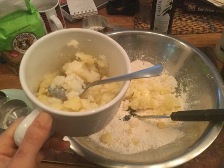 adding potato to flour