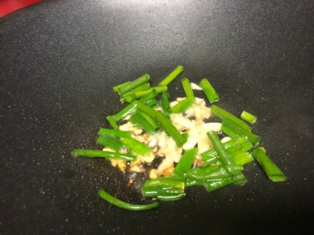 green onions, ginger and garlic cooking in oil