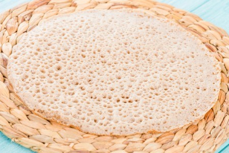 Close up of a tan injera sponge texture.