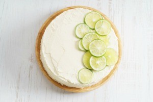 Frosted cake with sliced lime on top.
