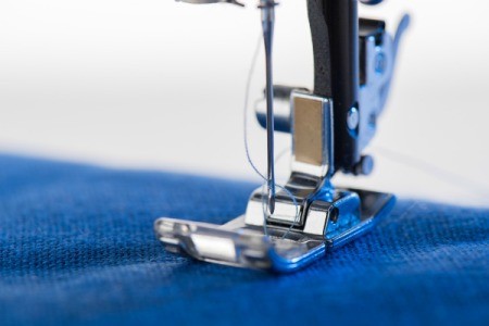 Closeup of sewing machine foot.