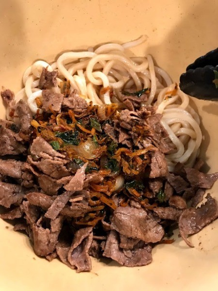meat and vegetables mixed with noodles