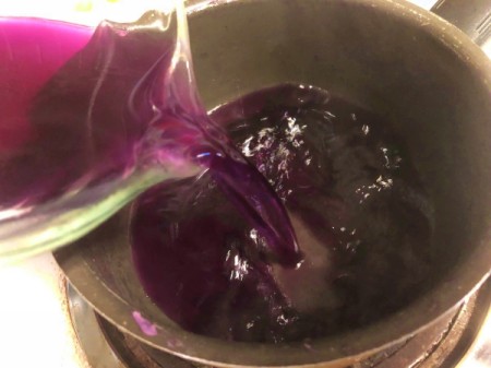 DIY Organic Food Colouring - adding liquid from cabbage back to pot to boil a bit longer