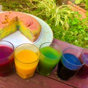 DIY Organic Food Colouring - containers of food colors next to a swirled cake