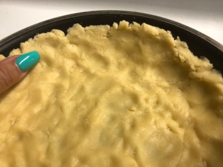 pressing crust dough in pan