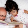 Father and daughter reading a book together