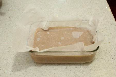 Cooked butterscotch pudding in a glass baking dish.