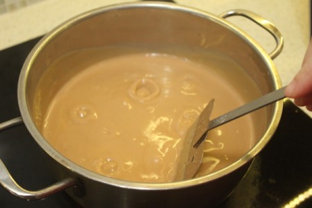Butterscotch pudding being cooked on the stove.