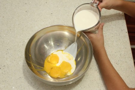 Wet ingredients for butterscotch putting being added to a bowl.