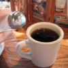 Adding salt to a cup of strong coffee.