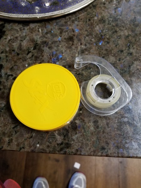 The second lid is placed on top and taped together.