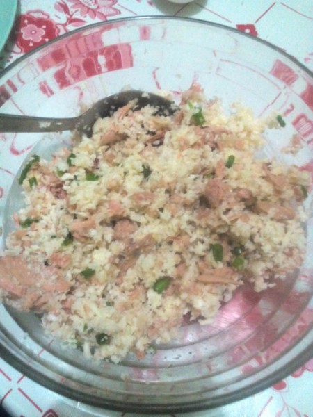 mixing bread crumbs, grated cheese, green onions and tuna in bowl