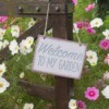 Welcome to my garden sign hanging on a gate.